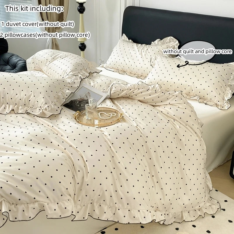 A set of white Korean lace duvet cover and pillowcases with a matching ruffled bedspread.