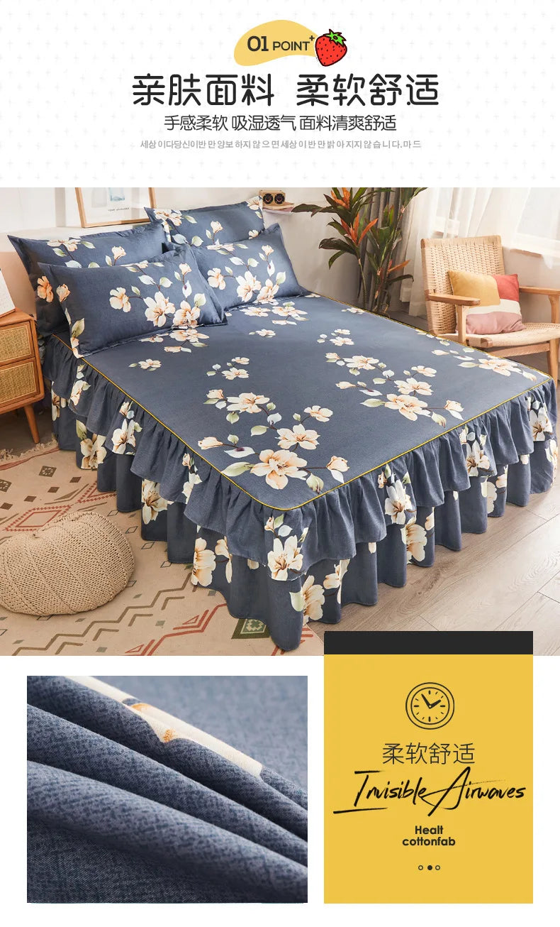 A dark blue printed bed skirt with white floral patterns is shown on a bed, highlighting its ruffled edge.