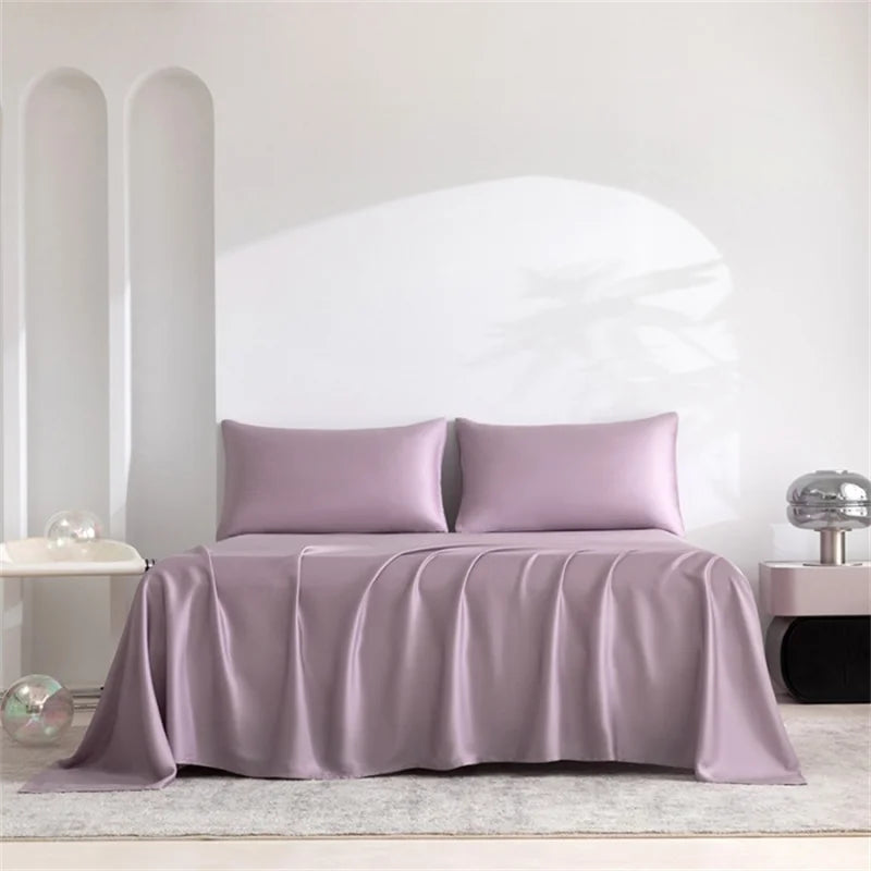 A luxury organic bamboo bed sheet set in mauve color draped over a bed.