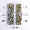 A clear plastic tray containing various sizes of light yellow glass rhinestones categorized by SS6, SS10, SS10, SS30, SS20, a