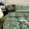 A set of striped bedding includes three counts: two pillowcases, one duvet cover, and a comforter.