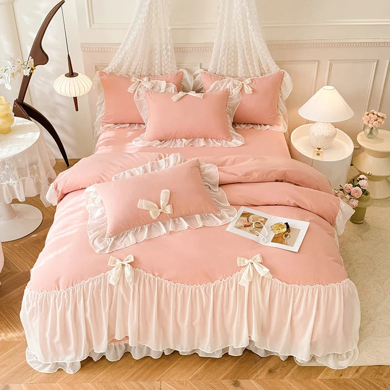A pink princess chiffon duvet cover set with ruffled trim and decorative pillows displayed on a bed.