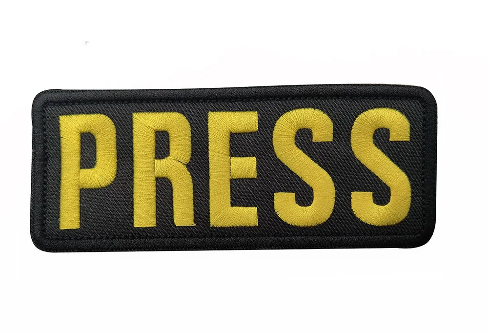 Black embroidered armband patch with yellow text reading PRESS