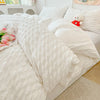 A white seersucker duvet cover and pillow set displayed on a bed with a light beige rug.