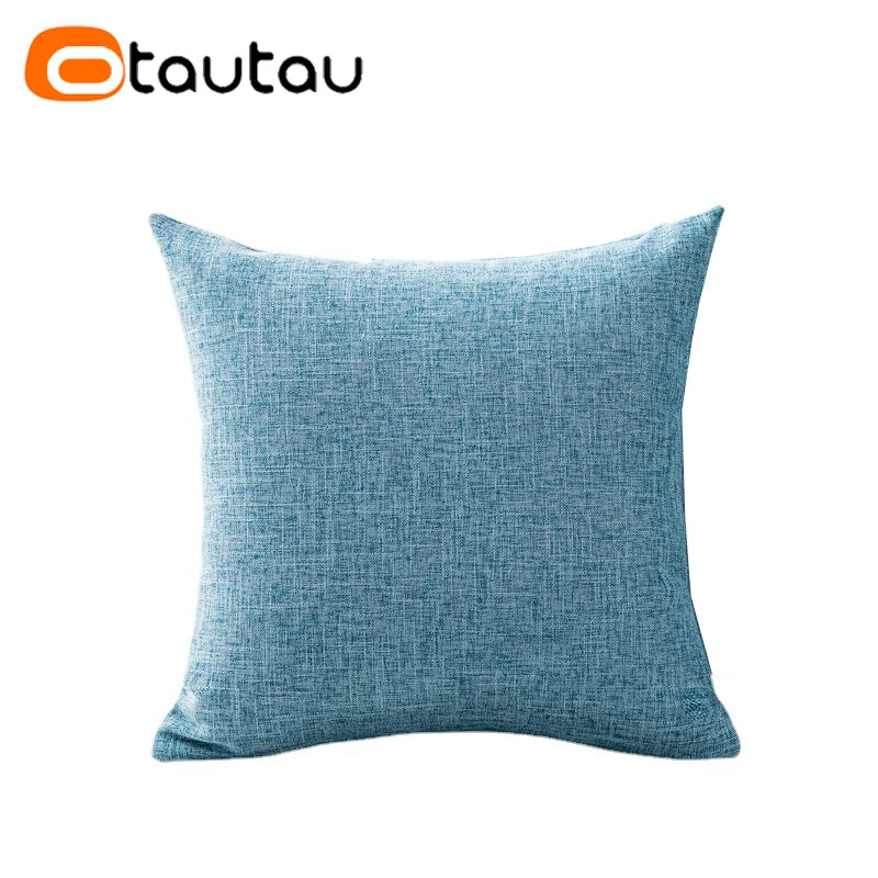 A light blue textured linen cushion cover with a button closure.