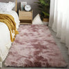A fluffy mauve shag rug placed on a wooden floor next to a white sofa and decorative items.