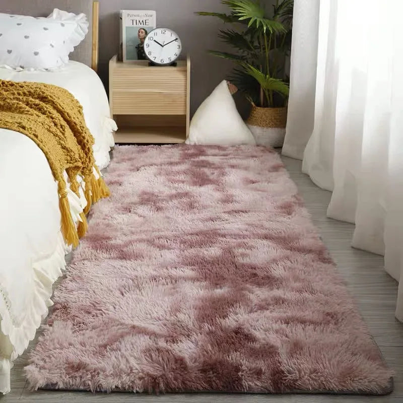 A fluffy mauve shag rug placed on a wooden floor next to a white sofa and decorative items.
