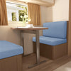 Light blue stretch covers on a dinette seat in a modern RV interior with natural light.