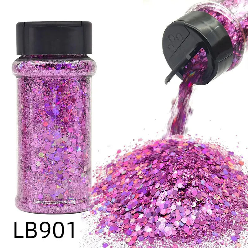 A purple glitter nail craft mix in a glass bottle is shown pouring its contents into a pile of iridescent pink and purple gli