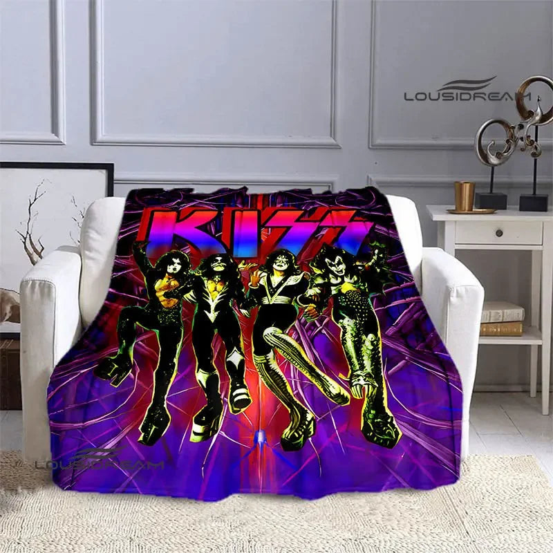 A purple and pink printed flannel travel blanket featuring a group of stylized figures.