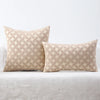 A beige chenille jacquard throw pillowcase with a diamond pattern resting on a white surface.