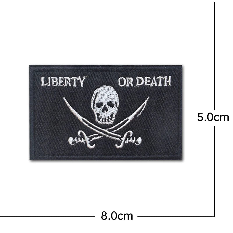 Black embroidery patch featuring a skull and crossbones design with the text Liberty or Death.