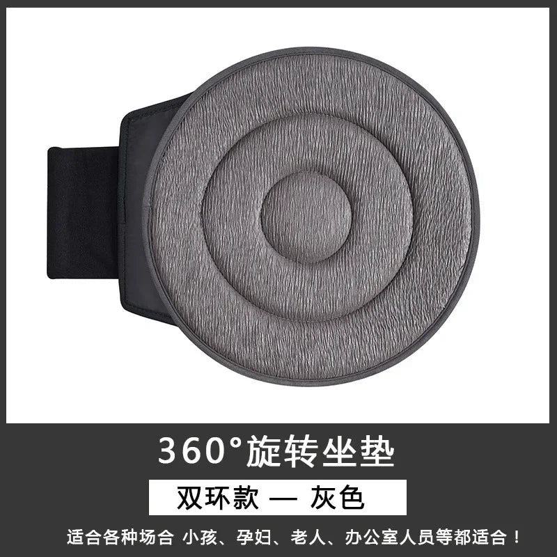 A gray 360-degree rotating car seat cushion with a black strap, suitable for various users.