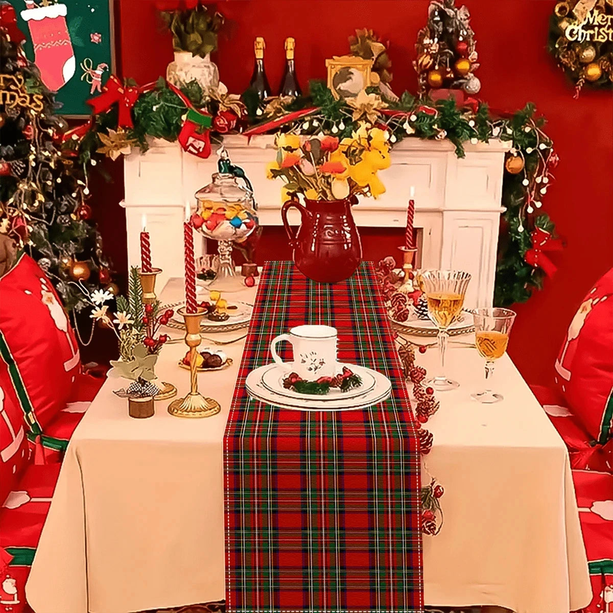 A festive holiday table setting featuring a tartan Christmas table runner on a white tablecloth with seasonal decorations.