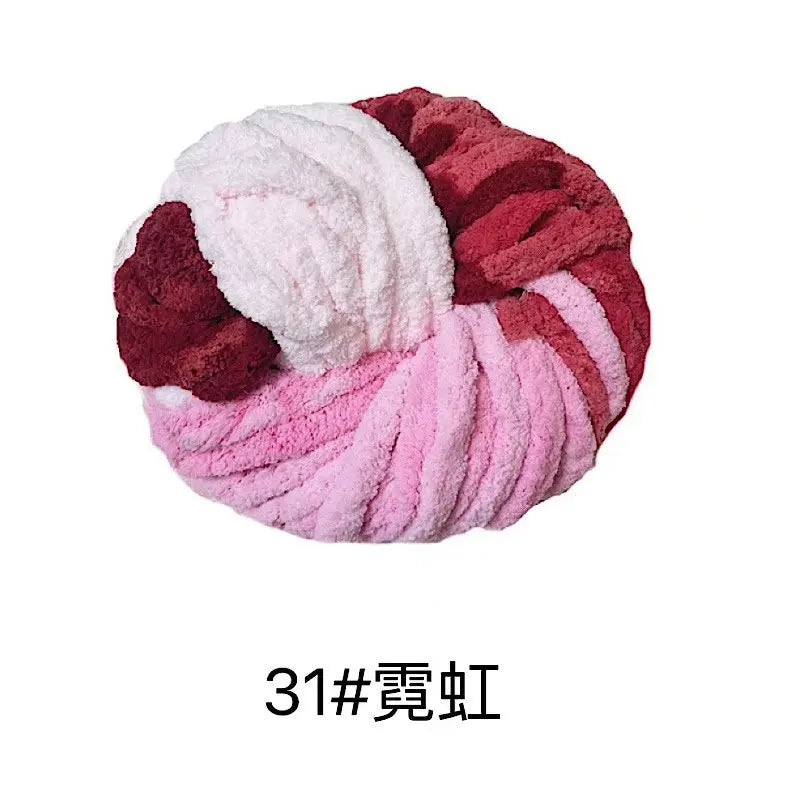 A ball of hand-woven chunky chenille yarn in shades of pink and maroon.