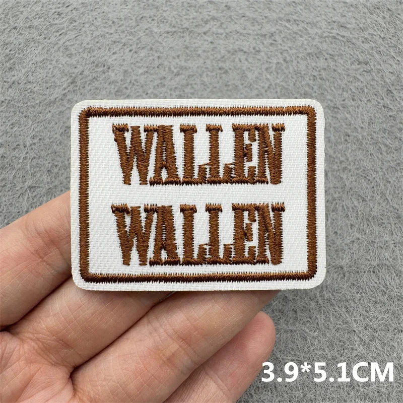 Two embroidered iron-on patches featuring the text WALLEN repeated in a rustic brown and white stitch pattern