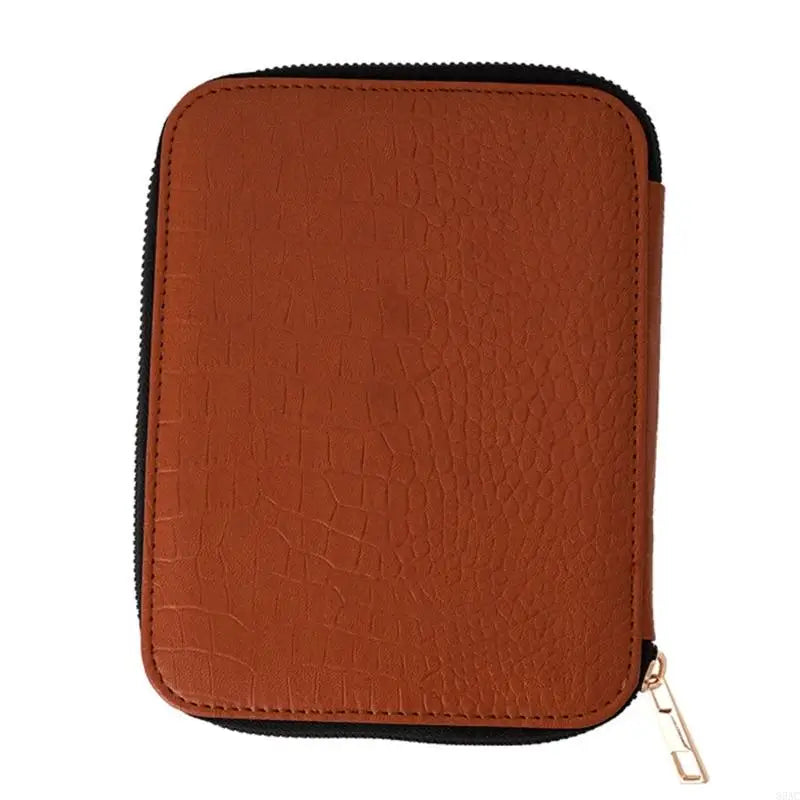 A brown leather knitting needle set with a black lining and gold clasp.