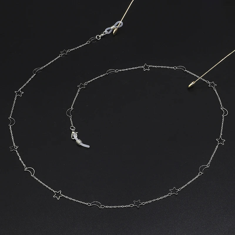 Silver locket necklace featuring a crescent moon and star charms on a delicate chain.