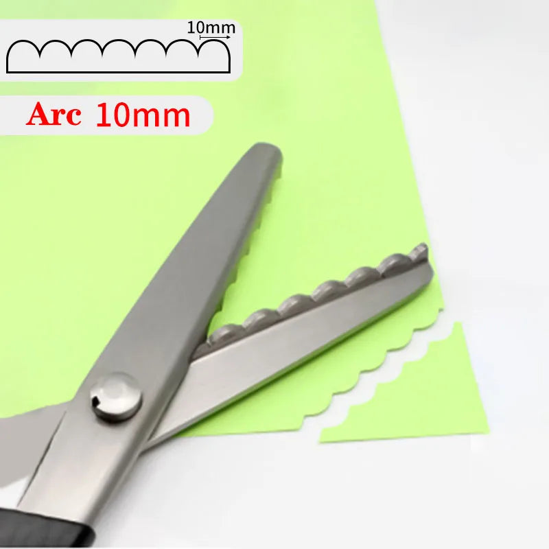 A pair of professional stainless steel tailor's shears with a serrated blade shown against a green background.