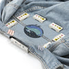 A denim garment shows several magnetic embroidery hoops attached to the fabric.