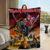 A person holds up a blanket featuring an Iron Maiden graphic of a skeleton devil with flames and a flag.