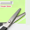 Stainless steel sewing scissors with a triangle-shaped serrated edge shown against a green background.