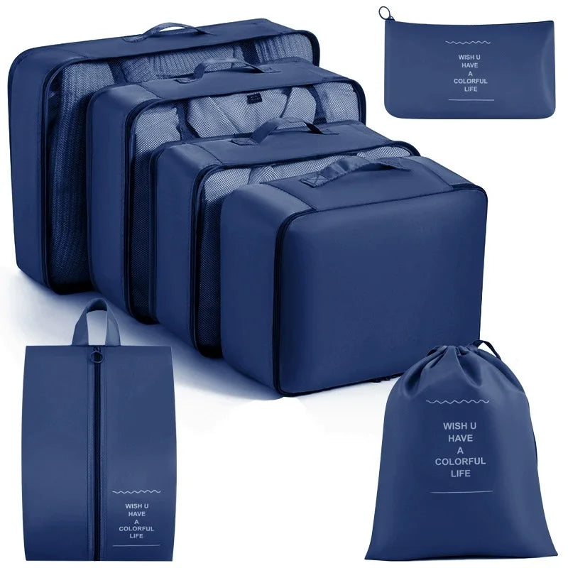 A set of dark blue travel storage organizers including a large zippered case and smaller pouches.
