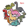 A set of 8 iron-on patches featuring various dinosaur and animal figures in different colors.