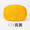 A ball of bright yellow organic cotton 4ply knitting yarn.