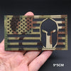 A tactical multicam national flag patch is shown being held, featuring the American flag design.