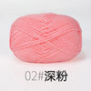 A ball of pink organic cotton 4ply knitting yarn with a textured, woven appearance.