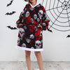 A woman models an oversized patchwork fleece hoodie featuring a skull print against a white background with black bats.