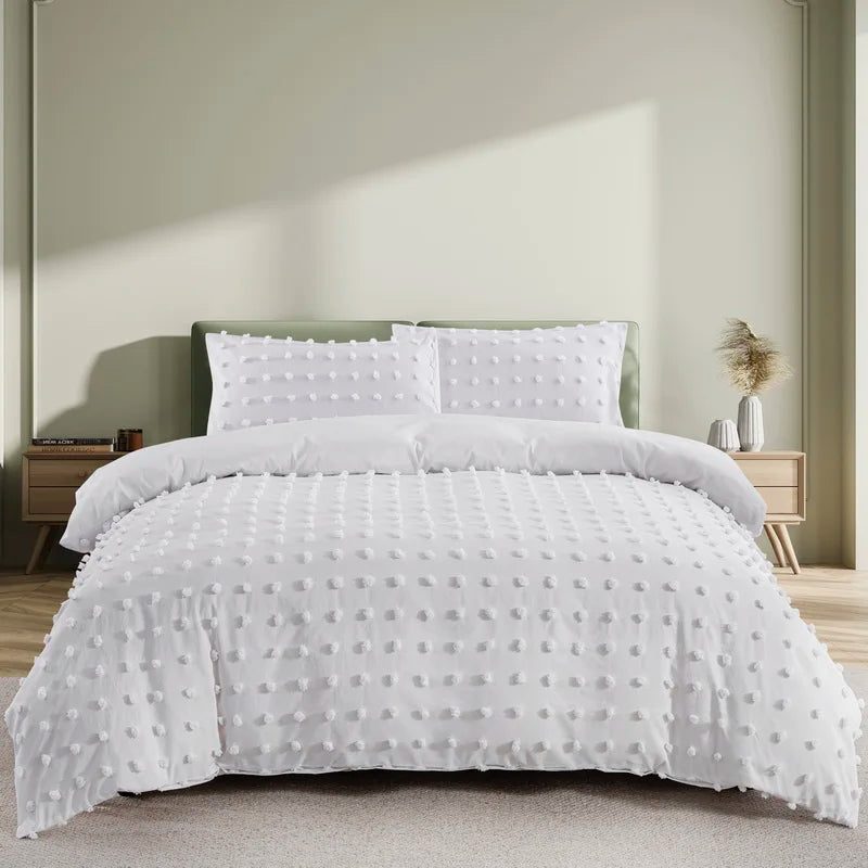 White tufted microfiber duvet cover set displayed on a bed with light green accents.