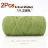 A ball of light green elastic yarn used for crafting and display.