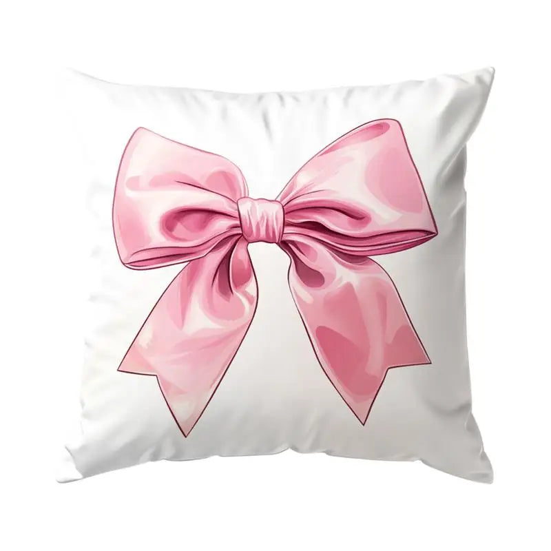 A decorative pillow cover featuring a pink bow pattern on a white background.