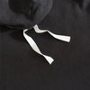 Black duvet cover set with white tie strings and pom-pom decoration