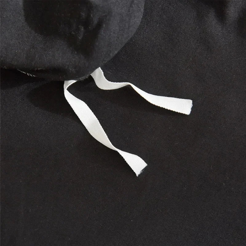 Black duvet cover set with white tie strings and pom-pom decoration