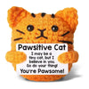An orange fluffy cat plush toy with black stripes and a humorous text on the tag.