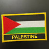 An embroidered patch featuring the flag of Palestine with horizontal stripes of black, white, and green.
