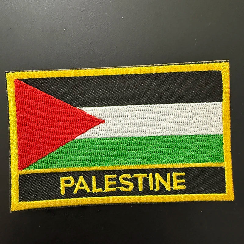 An embroidered patch featuring the flag of Palestine with horizontal stripes of black, white, and green.