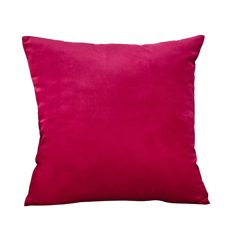 A square velvet throw pillow cover in a deep magenta color.