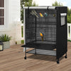 A black waterproof bird cage with a mesh front and a protective night cover is shown on a wooden deck.