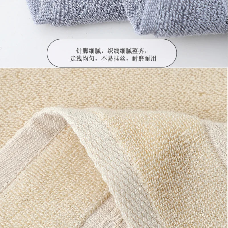 A close-up view of a beige cotton face towel fabric showing its texture and weave.