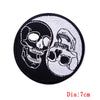 Black and white embroidered patch featuring two skulls