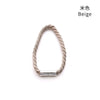 A beige braided magnetic curtain tieback clip.