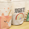 Three white fabric storage baskets with colorful cartoon designs and the text JUGUETES