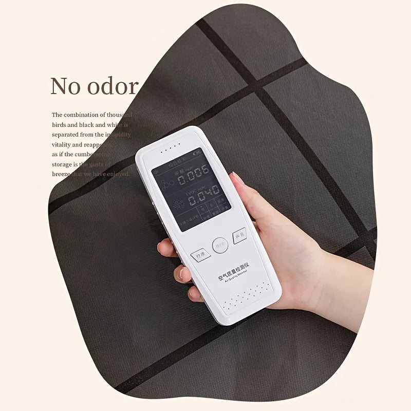 A hand holds a white electronic device, likely a pest repellent, placed on a dark fabric storage bag.