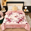A plush mink fleece king size blanket with a rose and peony floral pattern in pink and mauve tones.