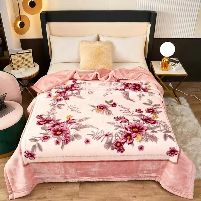 A plush mink fleece king size blanket with a rose and peony floral pattern in pink and mauve tones.