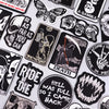 A collection of black and white embroidered skull patches featuring various themes like death and skulls.